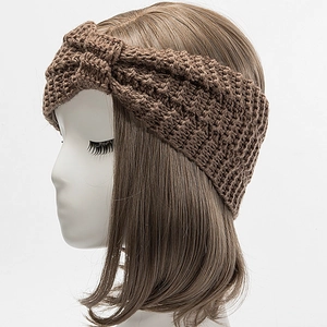Close-up of dark brown knitted headband with thick texture and stylish cross knot detail
