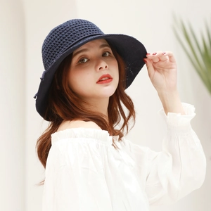 Detailed close-up of dark blue crochet sun hat with breathable diamond knit pattern