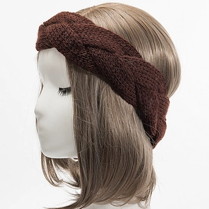 Close-up of thick cable knit winter headband in dark brown showing woven texture
