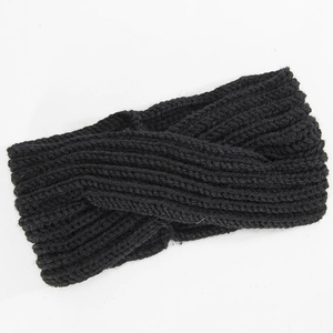 Close-up of the black ribbed knit headband showing the cross-knot texture and warm wool yarn