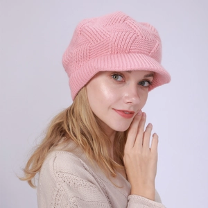 Close-up of pink twill knit peaked beanie with soft faux fur texture for women