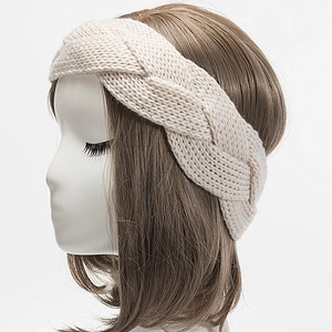 Close-up of cream chunky cable knit headband on mannequin for winter warmth and style