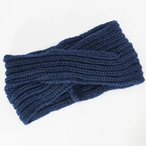 Macro detail of dark blue ribbed knit headband featuring a stylish twist knot design