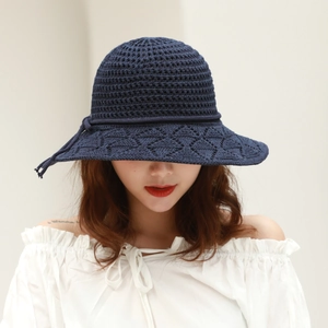 Detailed close-up of navy blue crochet knit sun hat with elegant diamond hollow pattern