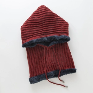 Close-up of thick wine red knit balaclava with warm navy blue plush faux fur lining