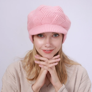 Detailed knit pattern of a pink winter brimmed hat with soft textured weave for women