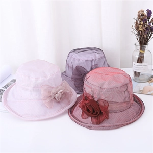 Three elegant organza sun hats with large floral details in pink, purple, and red hues