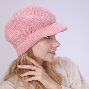 Detail showing pink knit visor beanie with textured diamond pattern and warm plush lining