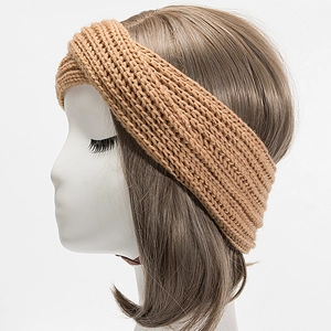 Detailed close-up of light brown knitted headband showing the twisted knot texture