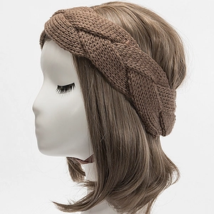 Close-up of brown cable-knit headband with thick texture on mannequin head