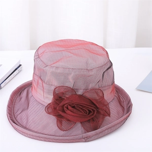 Detailed view of the dark red organza flower and mesh texture on the summer sun hat