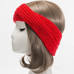 Detail of red knitted twist headband with thick knit texture on a mannequin