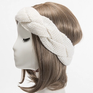 Detailed side view of beige chunky cable knit headband on mannequin head