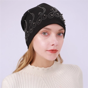 Detail of black cotton beanie with silver studs and rhinestones in wave pattern