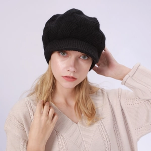 Detail of black twill knit visor beanie with fleece lining on a female model