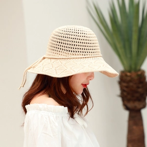Detailed knit pattern of beige crochet sun hat with breathable hollow design