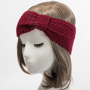 Detail des weinroten Strickstirnbands mit Wabenmuster und dekorativem Schleifenknoten
