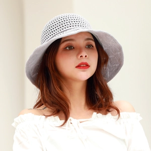 Close-up of light grey crochet sun hat featuring delicate hollow knit patterns and bow
