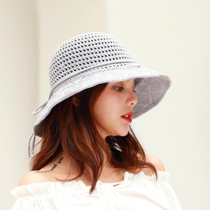 Detail of light purple knitted sun hat with hollow crochet pattern and side drawstring