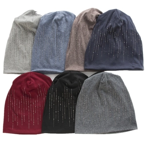 Detail view of multi-color cotton beanies featuring decorative vertical silver rhinestones