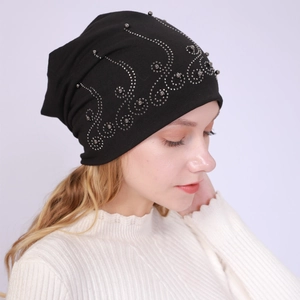 Detailed side view of black cotton beanie featuring intricate silver bead patterns