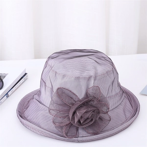 Detail of elegant dark purple organza sun hat with a large 3D mesh flower decoration