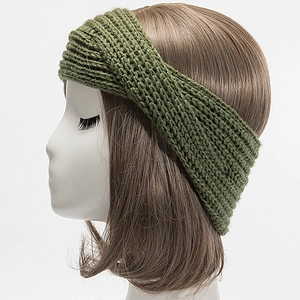 Close-up of olive green cable knit headband showing thick ribbed texture and twisted design