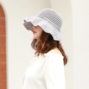 Close-up of light grey crochet knit sun hat with elegant wavy brim and mesh detail