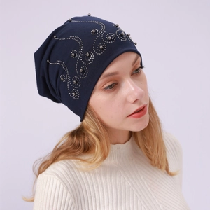 Detail of navy blue cotton beanie featuring elegant silver rivets and sparkling rhinestones