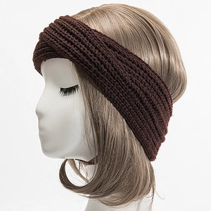 Detail showing the chunky rib-knit texture and crossover design of the dark headband