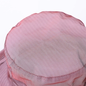 Macro texture of red-brown organza fabric on the crown of this women sun hat