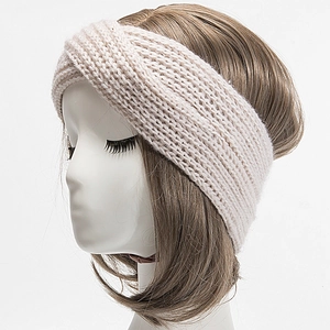 Detail of hand-knitted beige striped twist headband with premium ribbed texture
