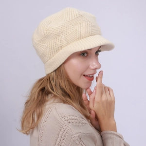 Detailed knit texture of a warm cream winter cabbie hat featuring a diamond lattice pattern