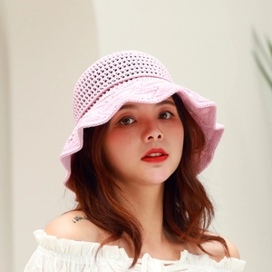 Detail of pink knitted sun hat showing breathable mesh pattern and scalloped wavy brim