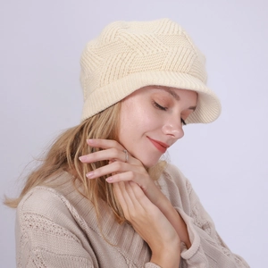 Detail of off-white twill knit beanie with brim showing thick warm texture on model