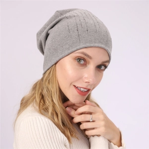Detailed view of gray slouchy beanie with vertical rows of sparkling rhinestones
