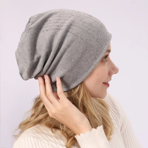 Detail view of grey slouchy beanie with silver rhinestones on soft cotton fabric