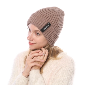 Detail of ribbed knit beanie in taupe featuring a Breakout logo patch for winter wear