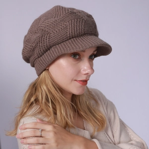 Close-up of a dark brown twill knit fleece-lined newsboy cap with warm winter texture