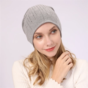 Detail of light gray knit beanie featuring vertical silver rhinestone embellishments