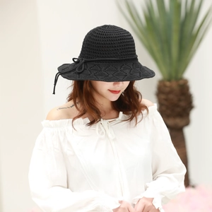 Detailed knit pattern and delicate bow on this black foldable sun hat for women