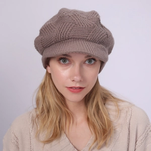 Detail of coffee brown cable knit newsboy hat with warm visor worn by model
