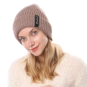Close-up of ribbed knit beanie with 'Breakout' letter patch and soft warm texture