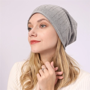 Detail of grey slouchy beanie with vertical rhinestones and soft cotton knit texture