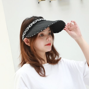 Close-up of black sun visor with white chain pattern headband and wide textured brim