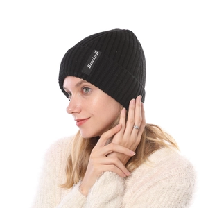 Detail of black ribbed knit beanie with white Breakout logo patch for winter warmth