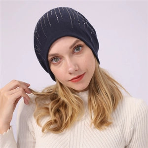 Detailed view of navy blue beanie featuring vertical silver rhinestone pattern decorations