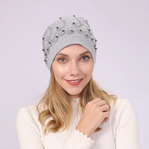 Detail of light grey cotton beanie featuring elegant silver bead floral embroidery