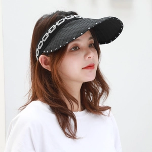 Detail of black sun visor featuring a chain pattern headband and textured brim for outdoors
