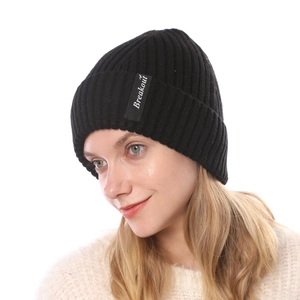 Close-up of black ribbed knit beanie with white Breakout letter patch detail